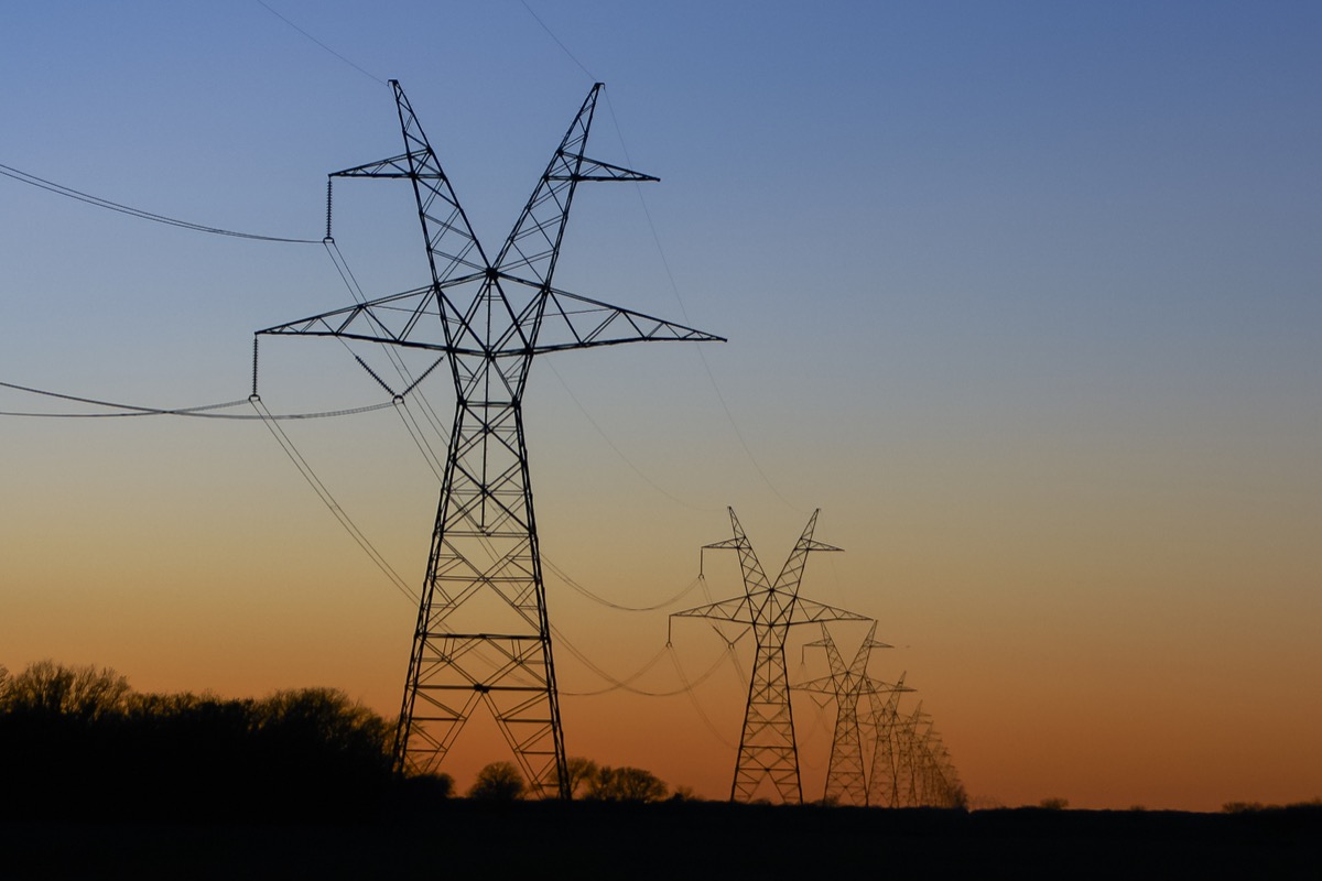 High-voltage transmission towers at sunset in East Texas